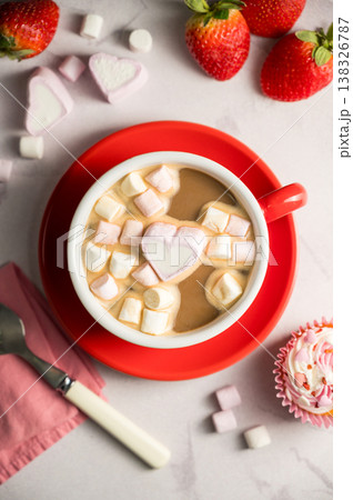 Valentine's Day background. Red cup of coffee with heart shaped marshmallows and strawberries Valentine's Day background. Red cup of coffee with heart shaped marshmallows and strawberries 138326787
