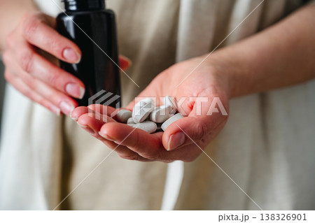 Woman hand closeup, holding capsules pills. Prescription medication, treatment sickness, seasonal cold flu concept Woman hand closeup, holding capsules pills. Prescription medication, treatment sickness, seasonal cold flu concept 138326901