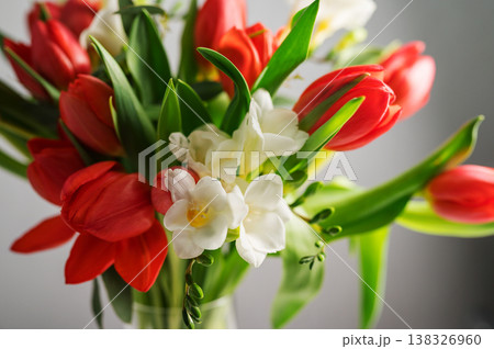 Spring floral background. Red tulips and Fresia white flower bouquet. Copy space Spring floral background. Red tulips and Fresia white flower bouquet. Copy space 138326960