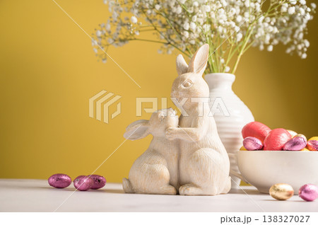 Easter chocolate colourful eggs in a bowl, cute bunnies. Spring holiday background. Easter chocolate colourful eggs in a bowl, cute bunnies. Spring holiday background. 138327027