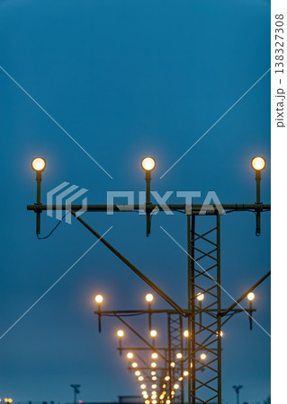 Sequential airport landing lights against blue sky Sequential airport landing lights against blue sky 138327308