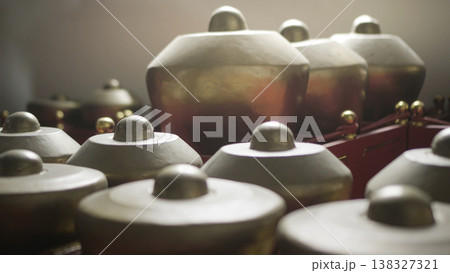 Magelang, Indonesia - December 8, 2025, Close-up of traditional Indonesian gamelan percussion instruments made of bronze Magelang, Indonesia - December 8, 2025, Close-up of traditional Indonesian gamelan percussion instruments made of bronze 138327321