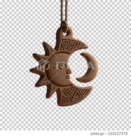 Ancient clay sun and moon pendant with tribal carvings hanging from rustic rope accessory. 138327378