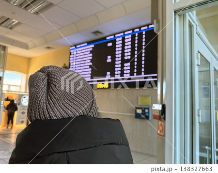 Waiting for the next train at a busy train station in winter 138327663