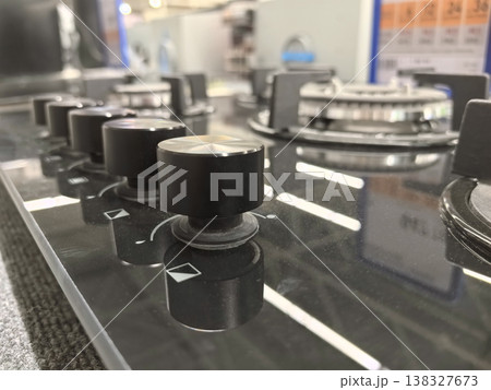 Modern kitchen stove burners shine in bright showroom setting Modern kitchen stove burners shine in bright showroom setting 138327673