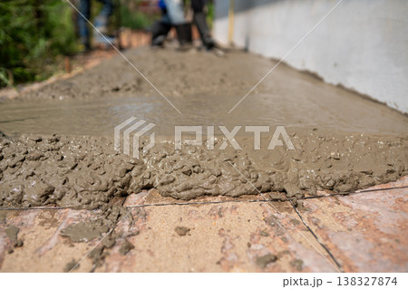 Concrete pouring process at construction site industrial action detailed view urban environment 138327874