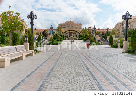 A large building with a red roof and white pillars. 138328142