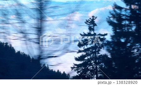 Blurred Trees And Clouds With Alpine Forest From Moving Car Side Window 138328920