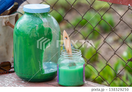 paint brush in a jar of solvent 138329250