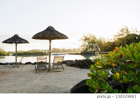 Empty sunbeds and umbrellas on tropical beach in Mauritius resort. 138329661