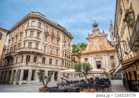 Mondovi (cuneo), italy, july 21,2024. Mondovi piazza maggiore capturing historic architecture, cobblestone square, and a cafe area under a cloudy sky Mondovi (cuneo), italy, july 21,2024. Mondovi piazza maggiore capturing historic architecture, cobblestone square, and a cafe area under a cloudy sky 138329779
