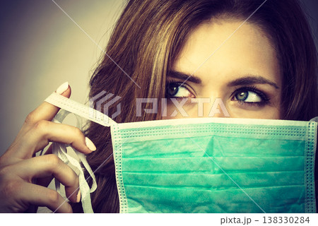 Female using protective face mask. 138330284