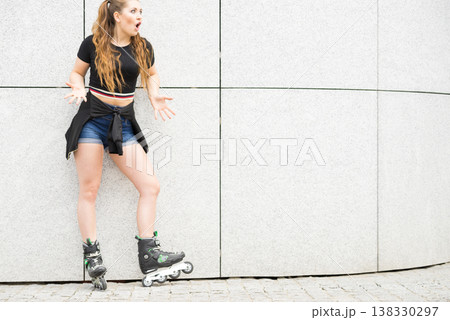 Young woman riding roller skates 138330297