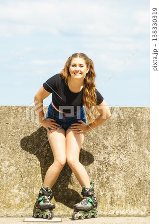 Fit girl with roller skates outdoor 138330319