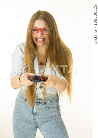 Gamer woman holding gaming pad Gamer woman holding gaming pad 138330325