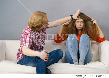 Man annoying young sad woman Man annoying young sad woman 138330436