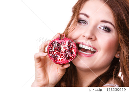 Cheerful woman holds pomegranate fruits, isolated Cheerful woman holds pomegranate fruits, isolated 138330639
