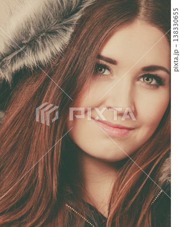 Happy woman wearing dark poncho coat with hood 138330655