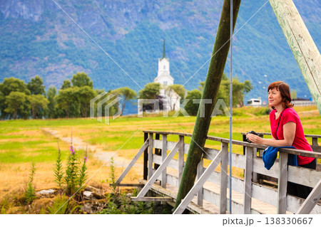 Tourist relaxing on bridge in village Oppstryn Norway Tourist relaxing on bridge in village Oppstryn Norway 138330667