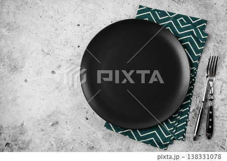Black Matte Plate with Cutlery on Concrete Background Black Matte Plate with Cutlery on Concrete Background 138331078