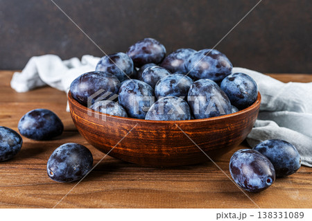 Fresh plums in a clay bowl. Fresh plums in a clay bowl. 138331089