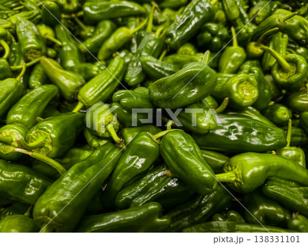 Top view of fresh organic green Padron peppers background pattern at farmers market 138331101