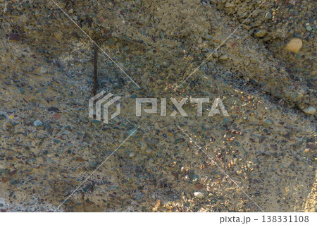 Reinforced concrete texture, exposed rebar, aggregate surface, construction detail 138331108