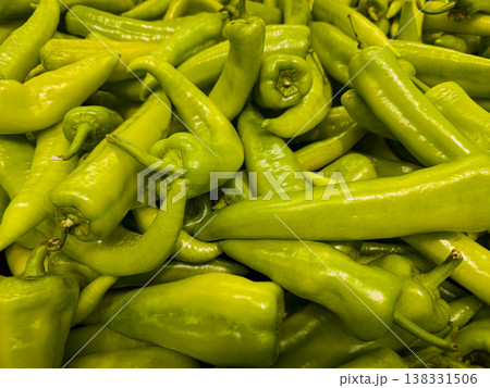 Top view of fresh organic long green chili peppers background pattern at farmers market 138331506