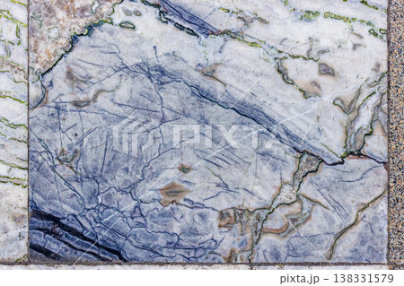 Worn Marble Floor Tiles with Intricate Blue and Green Veins 138331579
