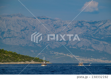 Tourist boats on Adriatic Sea with Biokovo Mountain Range Backdrop in Makarska riviera, Croatia Tourist boats on Adriatic Sea with Biokovo Mountain Range Backdrop in Makarska riviera, Croatia 138332192