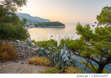 Serene coastal Makarska bay on Adriatic sea at sunrise in Makarska, Croatia 138332207