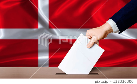 Denmark Parliamentary vote 2026. Hand placing a ballot in ballot box with the Danish flag in the background 138336300
