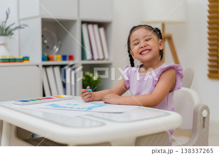 happy preschool child girl drawing and painting with colorful oil pastels on paper happy preschool child girl drawing and painting with colorful oil pastels on paper 138337265