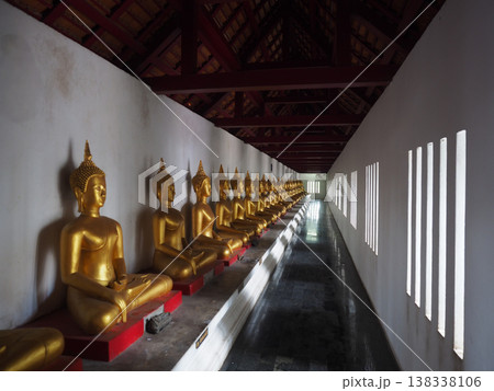 Golden Buddha statue row temple interior light Buddhism meditation Golden Buddha statue row temple interior light Buddhism meditation 138338106