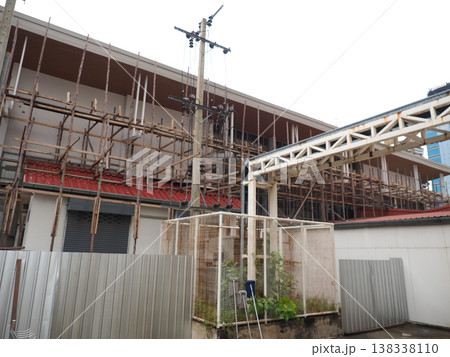 Construction scaffolding metal fence urban building site daytime scene Construction scaffolding metal fence urban building site daytime scene 138338110