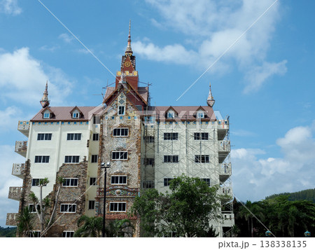 Ornate building renovation scaffolding tower architecture construction facade temple sky cloud 138338135