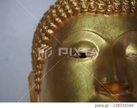 Golden buddha face closeup detail serene expression spiritual art Golden buddha face closeup detail serene expression spiritual art 138338164