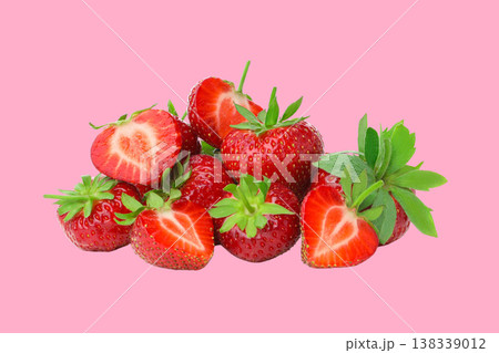 Fresh strawberries with green leaves lie on a pink surface Fresh strawberries with green leaves lie on a pink surface 138339012