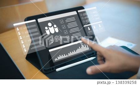 Human resource management system on digital tablet screen.Smart recruitment and hiring technology for modern business.Employee performance data analytics with hologram icons. Human resource management system on digital tablet screen.Smart recruitment and hiring technology for modern business.Employee performance data analytics with hologram icons. 138339258