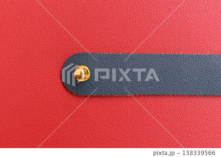 shiny red leather background with dark blue strap 138339566
