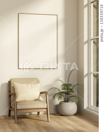 White frame on wall over wooden armchair and potted plant on parquet floor with sunlight from window 138339718