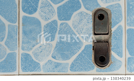 Above view of foldable steel frame for securing sliding steel doors. It was securely fastened to the floor which was covered with light blue patterned tiles. Above view of foldable steel frame for securing sliding steel doors. It was securely fastened to the floor which was covered with light blue patterned tiles. 138340239