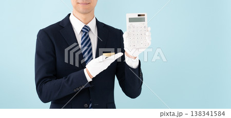 白手袋で計算機を持つ男性　手元 138341584