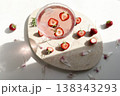 Pink strawberry margarita cocktail with sugar rim on marble tray. Fresh halved berries floating in sparkling rose drink with ice and sunlight shadows for summer party lifestyle. 138343293