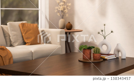Cactus and pot plant on tray with books and creative vases on wooden table aside sofa in living room Cactus and pot plant on tray with books and creative vases on wooden table aside sofa in living room 138343457