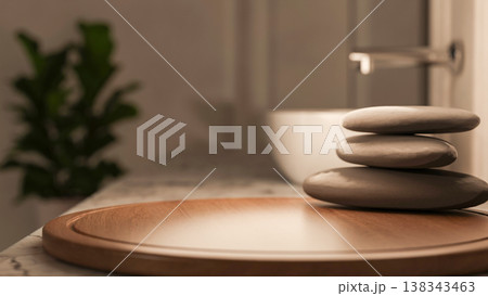 Spa massage stones on round wooden tray at marble sink counter in dim lit bathroom of a modern house Spa massage stones on round wooden tray at marble sink counter in dim lit bathroom of a modern house 138343463