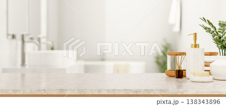 Soap and body wash and diffuser on white marble counter table across tub and sink in modern bathroom Soap and body wash and diffuser on white marble counter table across tub and sink in modern bathroom 138343896
