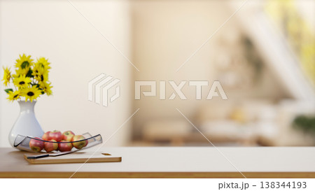 Apples on glass plate and knife on cutting board on wooden counter across blurred bright living room Apples on glass plate and knife on cutting board on wooden counter across blurred bright living room 138344193
