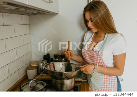 beautiful young chef decorating delicious dessert beautiful young chef decorating delicious dessert 138344444