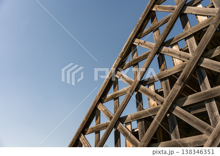 Close-up of abstract wooden framework with diagonal beams creating geometric patterns 138346351